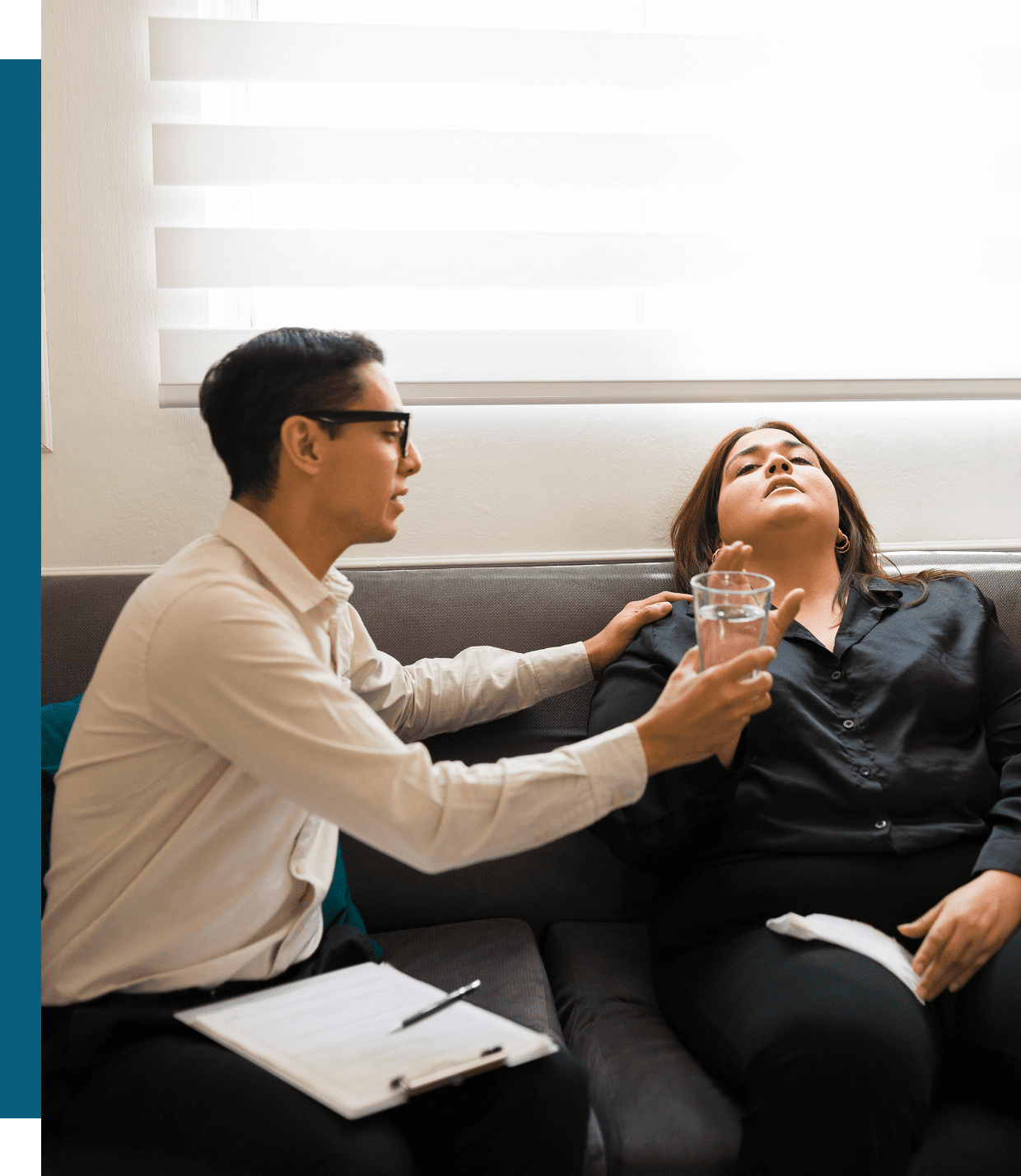 A therapist conducting hypnosis on a female patient in a bright room.