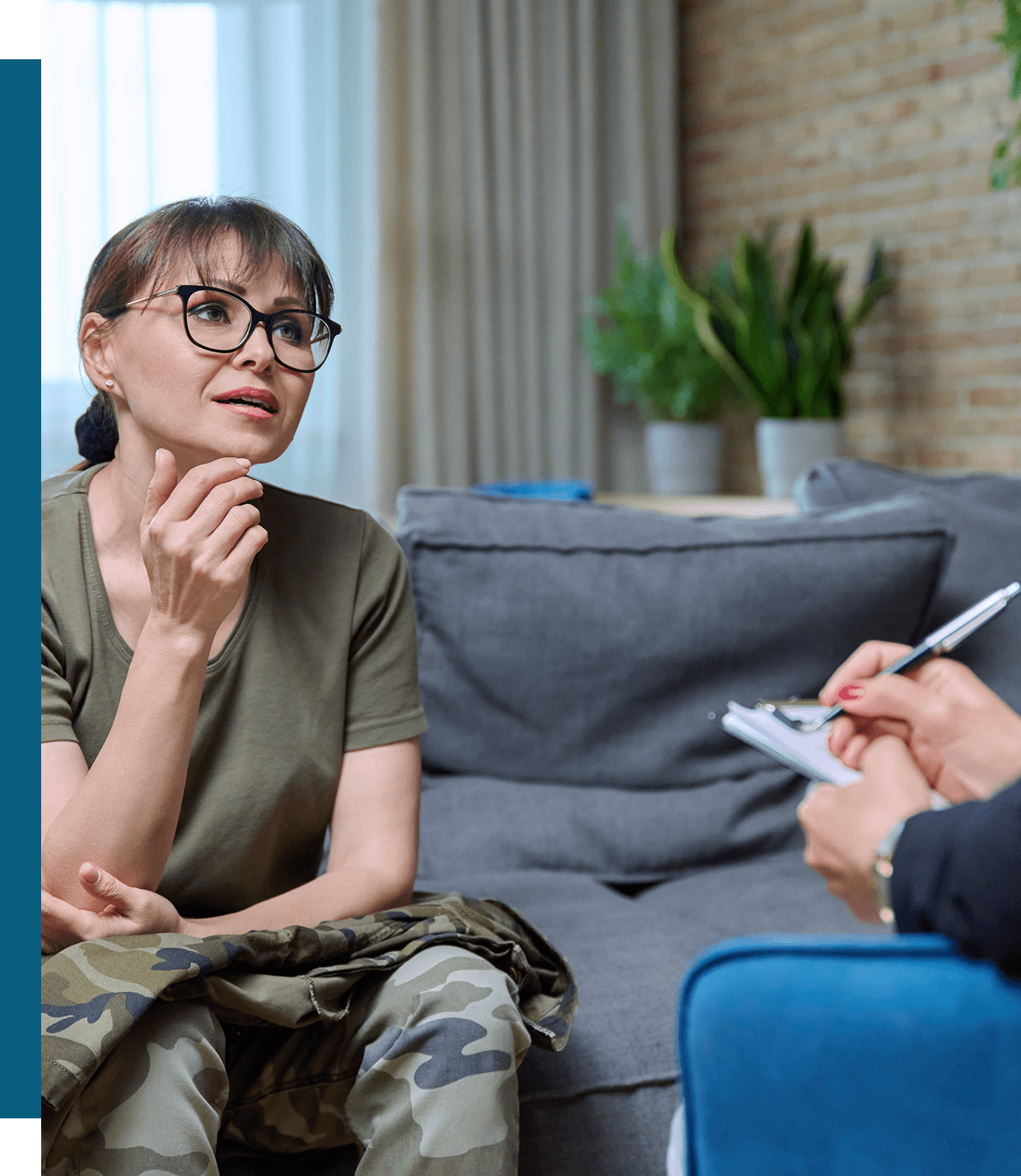 A woman attentively listens during a therapy session.